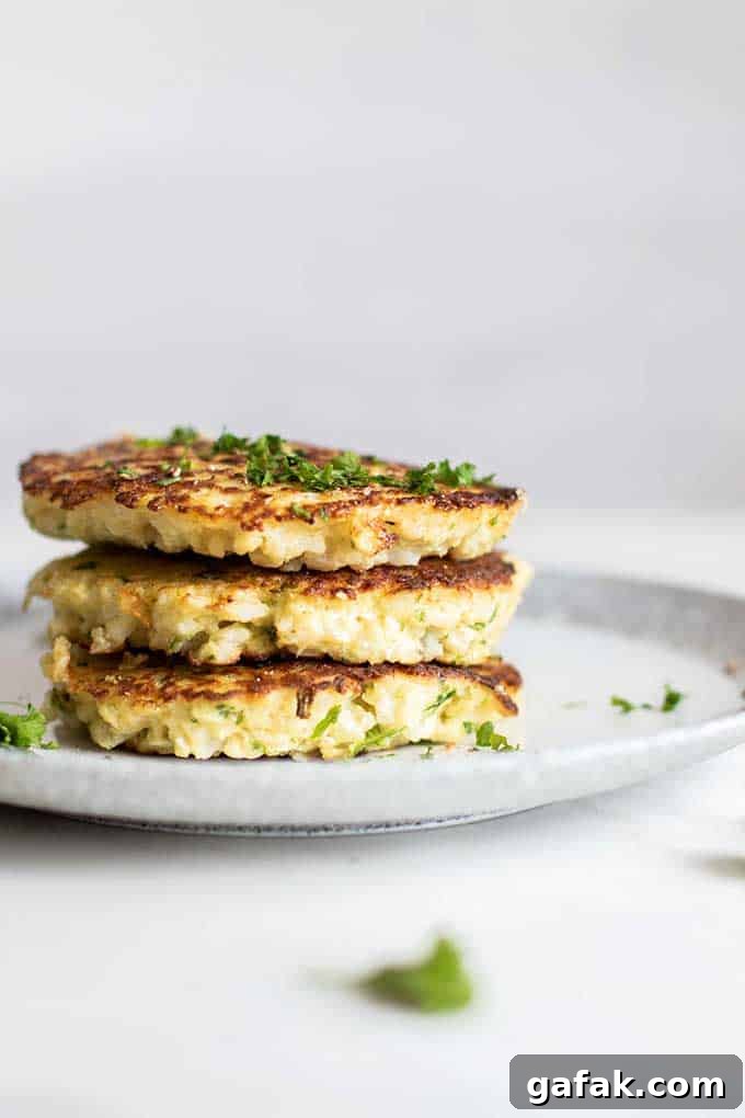 A stack of golden brown paleo cauliflower fritters.